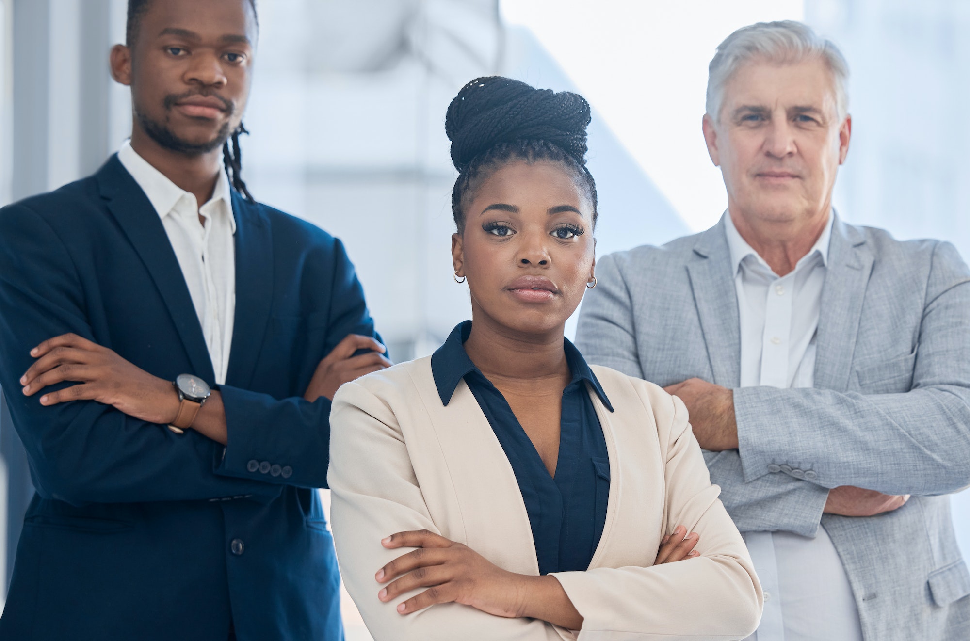 Portrait, arms crossed and black woman leadership with business people in office for company goals.